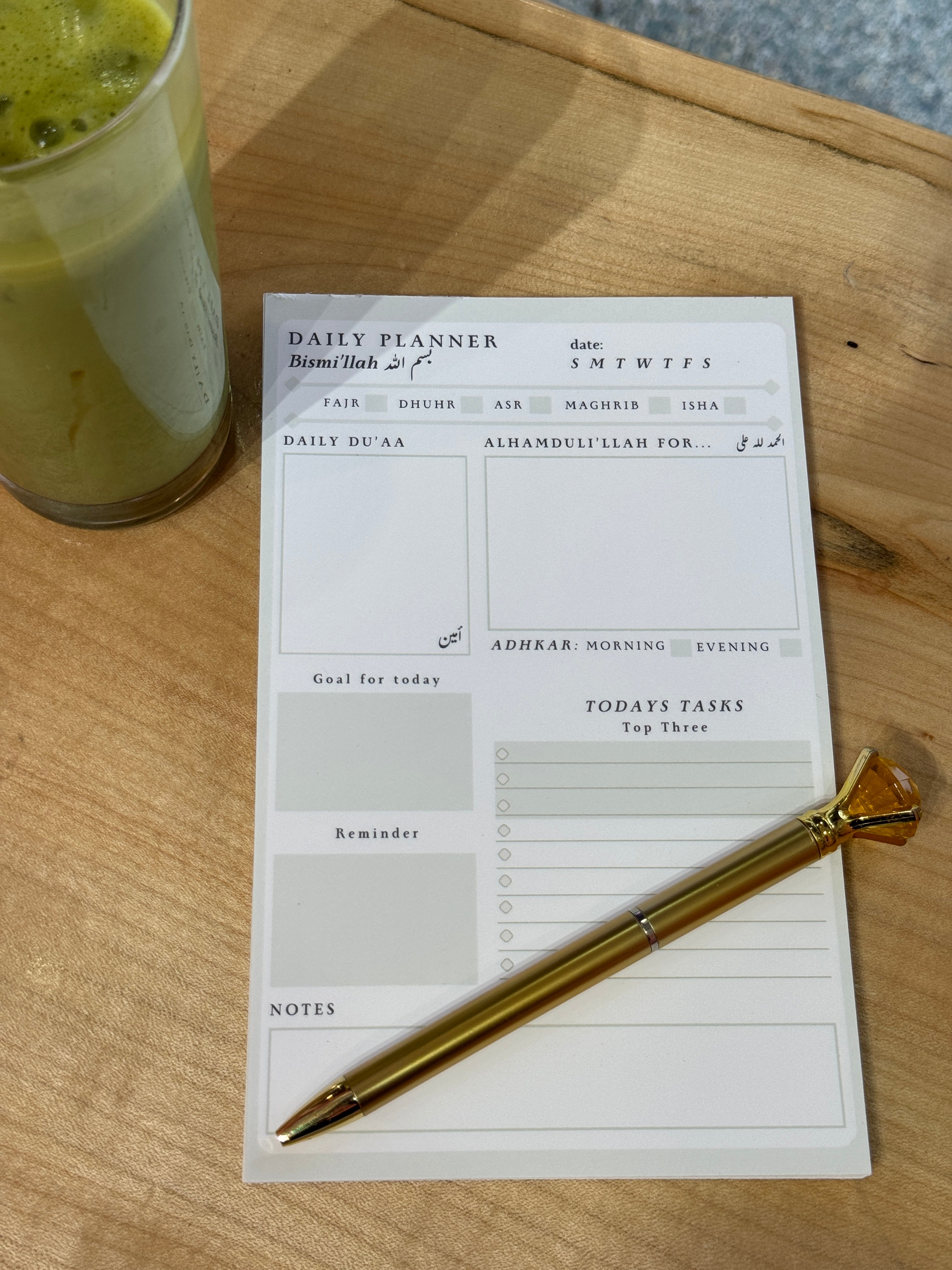 Daily planner with a pen on a wooden surface